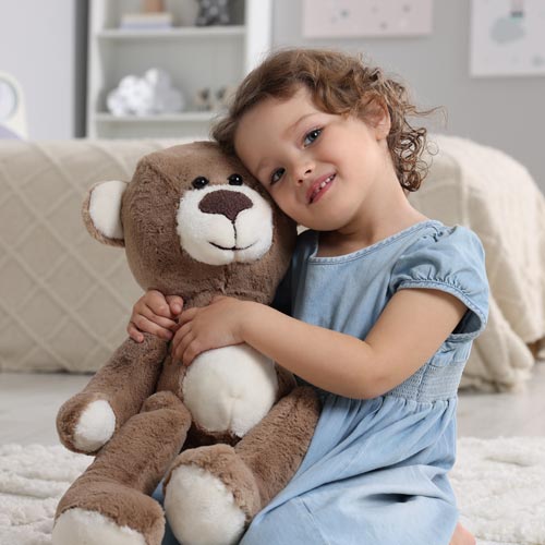 Happy child reunited with her lost teddy bear.